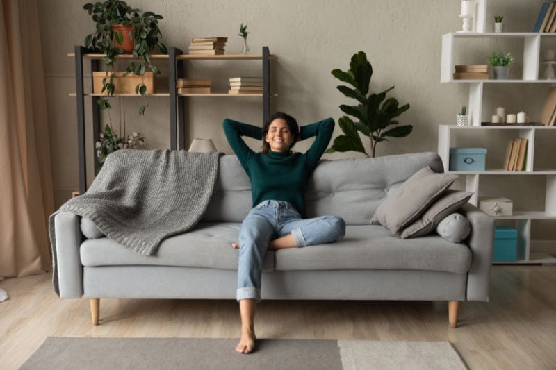 Clean Your Indoor Air With Air Scrubber by Aerus. Women on couch.